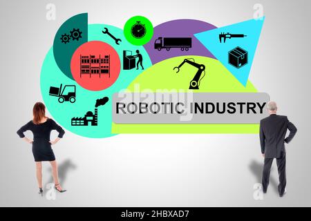 Robotic industry concept drawn on a wall watched by business people Stock Photo