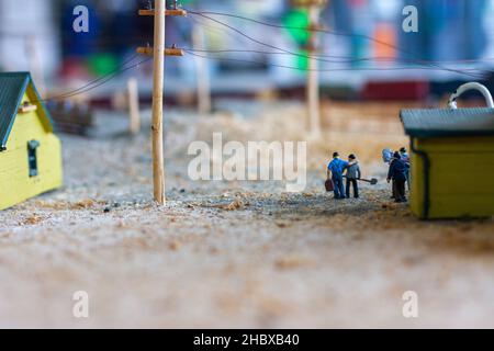 A miniature of a train station with workers Stock Photo