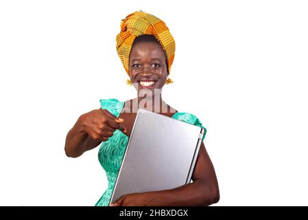 beautiful young woman pointing finger on laptop and looking at camera smiling. Stock Photo