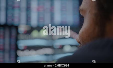 Young adult man, crypto stock chart monitor background he is analyzing crypto coin Stock Photo
