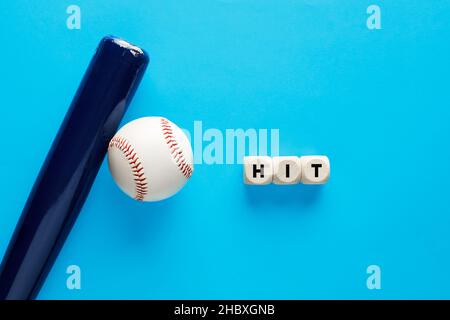 Baseball bat and a ball on blue background with the word hit. Batter ratio in baseball concept. Stock Photo
