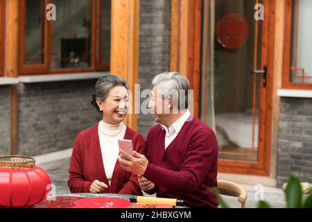 Elderly couple using smartphones for video call in the new year Stock Photo