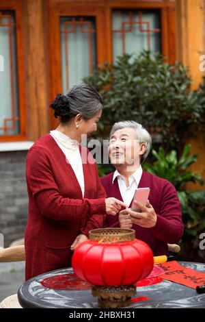 Elderly couple using smartphones in the new year Stock Photo