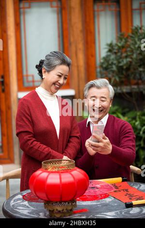 Elderly couple using smartphones in the new year Stock Photo