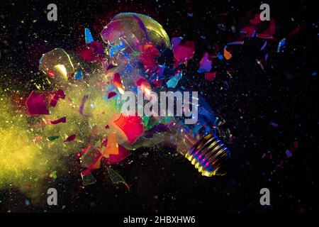 explosion of a colorful light bulb on black. high speed photography. Stock Photo