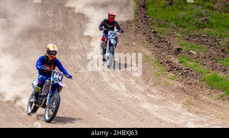 RUSSIA, Novoshakhtinsk - MAY 08, 2021: Motorcyclists ride sports cross-country motorcycles off-road Stock Photo