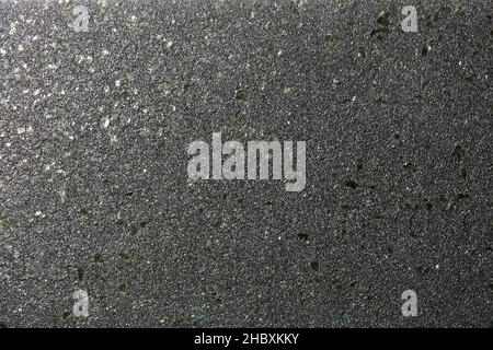 Smooth diagonal gradient with glitter of small colored granules on a black background with green malachite splashes for party decor. Stock Photo