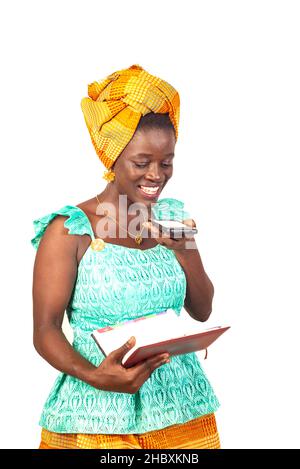 beautiful young woman talking on mobile phone speaker with a red notebook in hand. Stock Photo
