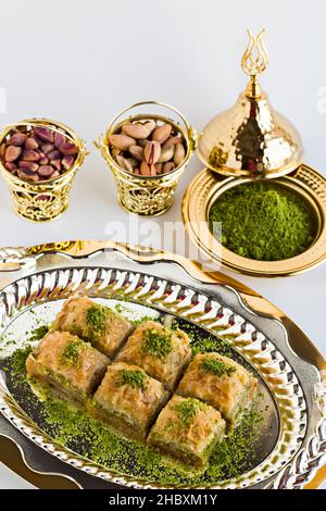 Traditional Turkish Dessert Baklava served with pistachios on a white background.Feast concept Stock Photo