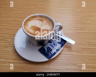 https://l450v.alamy.com/450v/2hbxm7y/cup-of-lavazza-coffee-on-a-wooden-table-2hbxm7y.jpg