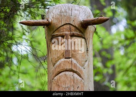 The image of the Slavic deity Veles carved from a tree trunk on a neo-Pagan temple in the forest. Kaluzhskiy region, Russia. Veles - the god of cattle Stock Photo