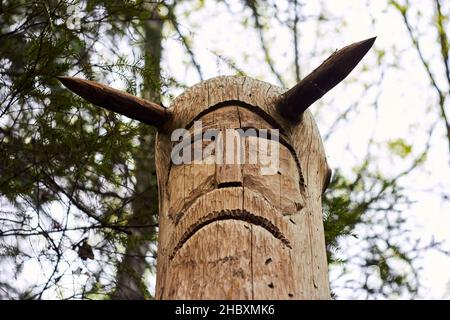 The image of the Slavic deity Veles carved from a tree trunk on a neo-Pagan temple in the forest. Kaluzhskiy region, Russia. Veles - the god of cattle Stock Photo