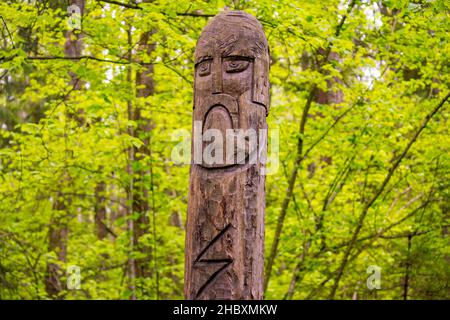 The image of the Slavic deity Veles carved from a tree trunk on a neo-Pagan temple in the forest. Kaluzhskiy region, Russia. Veles - the god of cattle Stock Photo