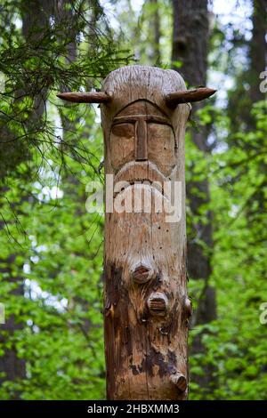 The image of the Slavic deity Veles carved from a tree trunk on a neo-Pagan temple in the forest. Kaluzhskiy region, Russia. Veles - the god of cattle Stock Photo