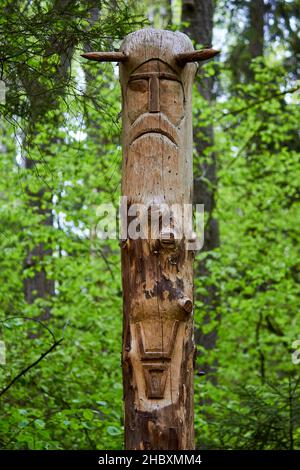 The image of the Slavic deity Veles carved from a tree trunk on a neo-Pagan temple in the forest. Kaluzhskiy region, Russia. Veles - the god of cattle Stock Photo