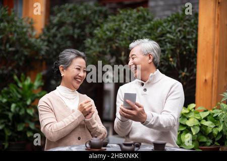 Old couple using a smartphone Stock Photo