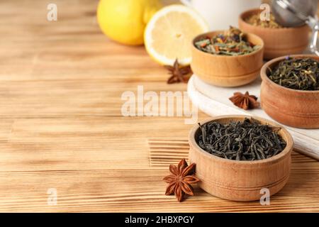 Concept of cooking tea with different types of tea on wooden background Stock Photo