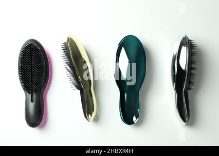 Colored plastic hair brushes on white background Stock Photo