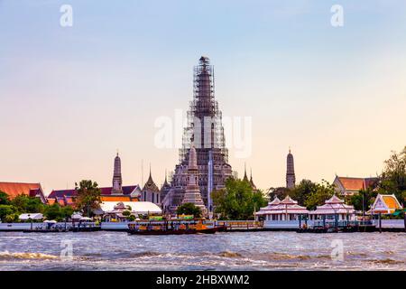 Wat Arun (Temple of Dawn) undergoing renovations and Chao Phraya River in Bangkok, Thailand Stock Photo