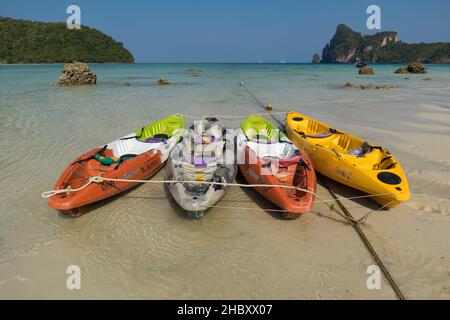 A beautiful shot of a bunch of canoes in a sea in Loh Dalum Bay in Koh Phi Phi, Phuket Stock Photo