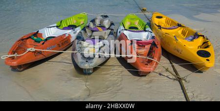 A beautiful shot of a bunch of canoes in a sea in Loh Dalum Bay in Koh Phi Phi, Phukety Stock Photo