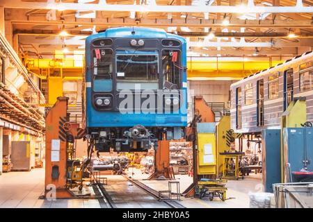 Passenger carriage locomotive of the subway, electric transport in the depot on suspended jacks for service maintenance Stock Photo