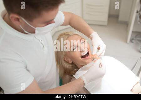 Dental surgeon making teeth replacement procedure Stock Photo
