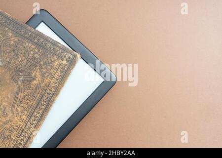 E reader emerging from an very old book, with beautiful covers Stock Photo