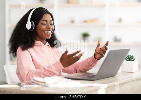 Cheerful african american woman having video chat with colleagues Stock Photo