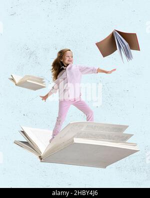 Contemporary art collage of little cheerful girl, child surfing on open book isolated over light blue background Stock Photo