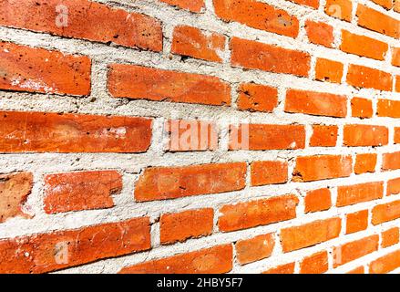 Weathered red brick wall as background. View from the angle Stock Photo