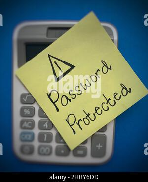 Password protected text written on sticky note on top of a blurred calculator background - a reminder to always avoid from hacker hacking your your Stock Photo