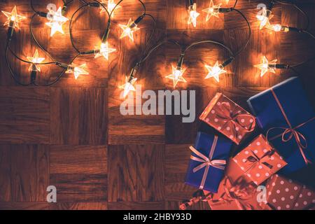 Christmas decoration with gift boxes and christmas star lights. Merry christmas greeting card Stock Photo