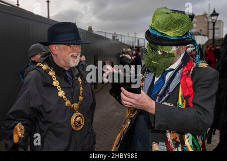 Town Mayor Councillor Jonathan How talking to Simon Reed at the Montol Festival parade in Penzance in Cornwall. The festival is a revival or reinterpr Stock Photo