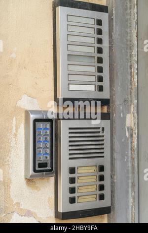 Old-fashioned vintage doorbells with blank nameplates. An outdoor intercom outside a residential building with empty name cards. Vertical photo Stock Photo