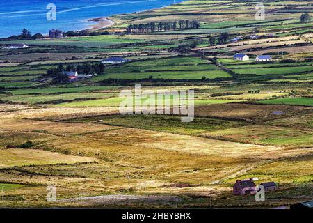 View from Coomanaspig Pass of meadows, fields and individual houses, Skellig Ring panoramic road, Portmagee, Iveragh Peninsula, Kerry, Ireland Stock Photo