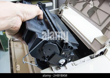 Technicians replacing toner in laser printer concept office supplies repair Stock Photo