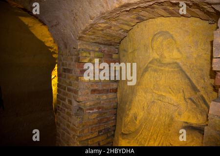 Relief of priest, Grotte del Cantinone, Osimo, Province of Ancona, Italy Stock Photo