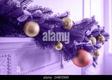 A branch of a Christmas tree with Christmas toys in pantone color. Horizontal photo. Stock Photo