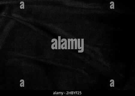 Close up view of monochromatic dark moody denim jeans fabric for texture background Stock Photo