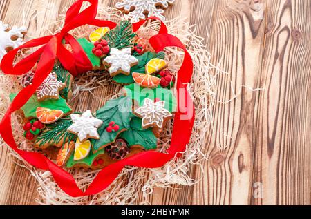 Christmas gingerbread in the form of a Christmas wreath lies on a wooden background. gingerbread cookies Stock Photo