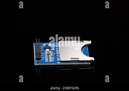 SD Card Reader Writer Module for microcontroller board projects isolated in black background Stock Photo