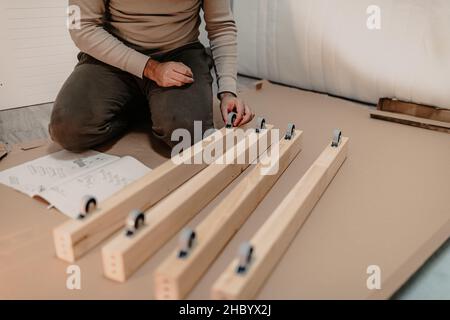 man assembling new furniture bought for home Stock Photo