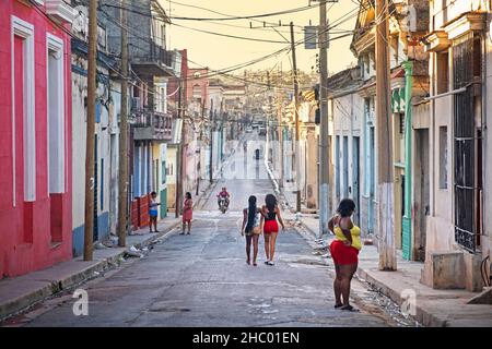 Afro-Cuban women walking street at sunset in the colonial city center of Matanzas on the island Cuba, Caribbean Stock Photo