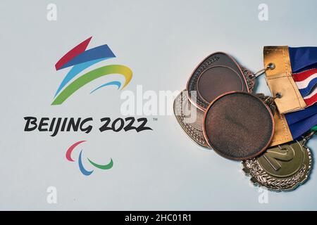 14 December 2021 - Los Angeles, USA: Paralympics medals and Beijing 2022 Paralympic games symbol. Winning medals at 2022 Winter Paralympics in Beijing Stock Photo