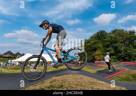 Boy riding a bicycle at opening event at Ormiston BMX pump track, East Lothian, Scotland, UK Stock Photo