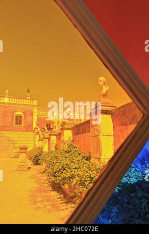 Stained glass window-gravel path-large planters-walltop busts-pink façade. NeoRococo palace-Estoi-Algarve-Portugal-024 Stock Photo