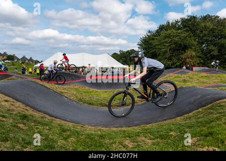 Boy riding a bicycle at opening event at Ormiston BMX pump track, East Lothian, Scotland, UK Stock Photo
