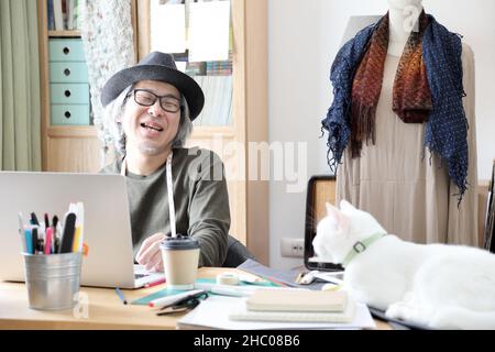 The senior Asian designer working in the studio. Stock Photo