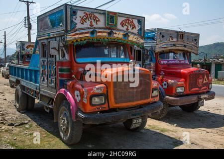 Decorated and painted heavy goods haulers parked by a road in Kathmandu, Nepal. Stock Photo